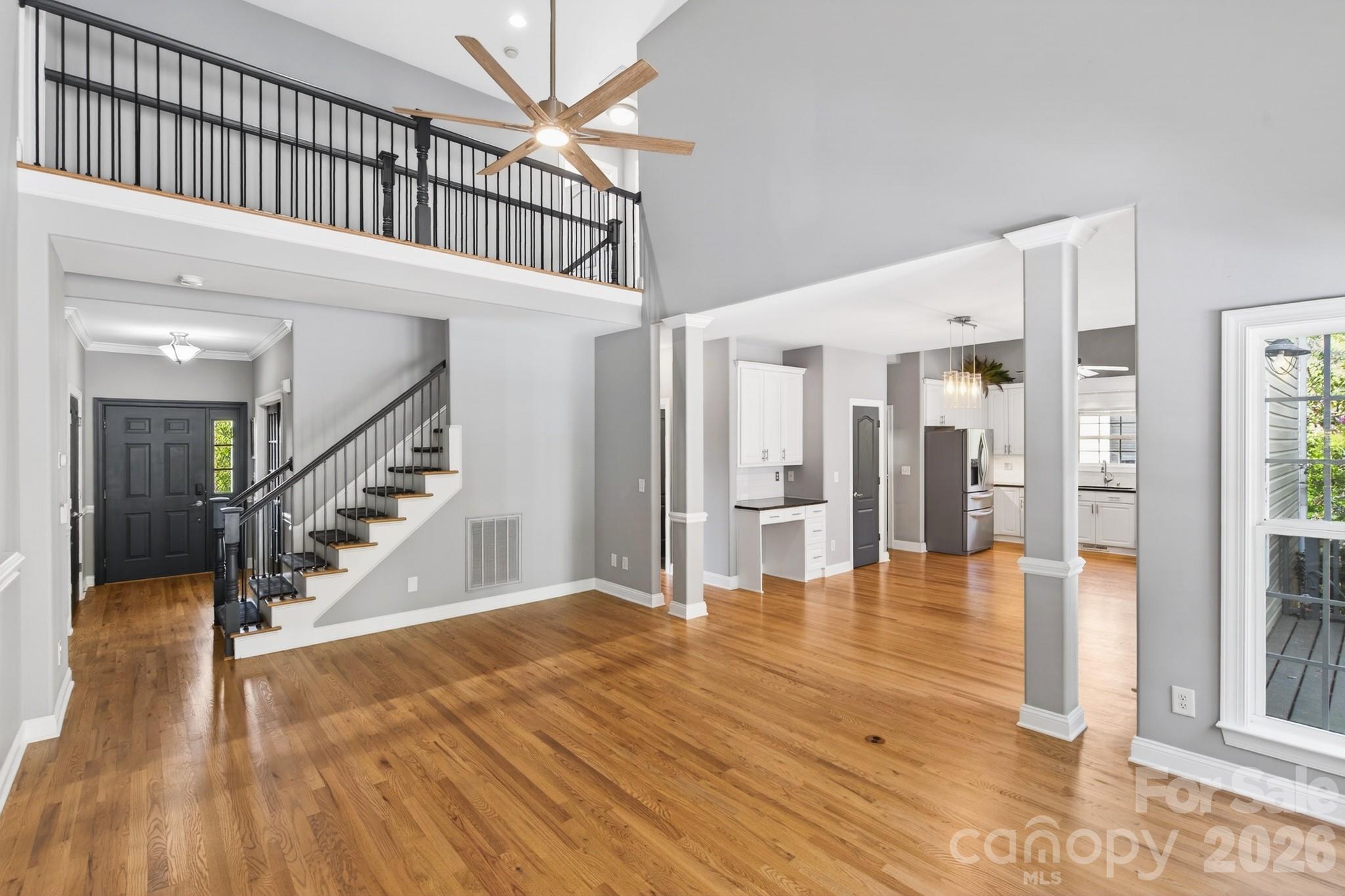 9101 Pitcairn Drive Tega Cay, SC 29708 - Photo 15 of 48 a view of a hallway with wooden floor and staircase