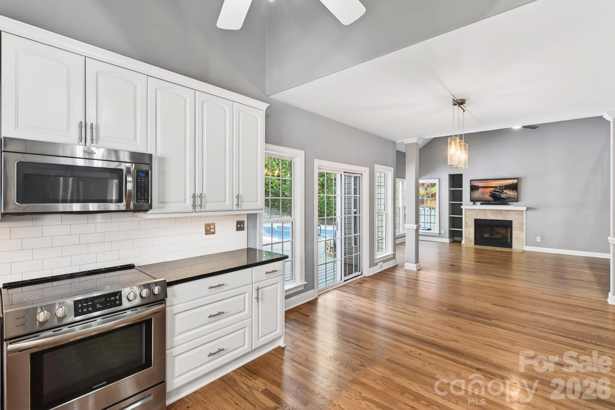 9101 Pitcairn Drive Tega Cay, SC 29708 - Photo 16 of 48 a kitchen with stainless steel appliances a stove microwave and cabinets