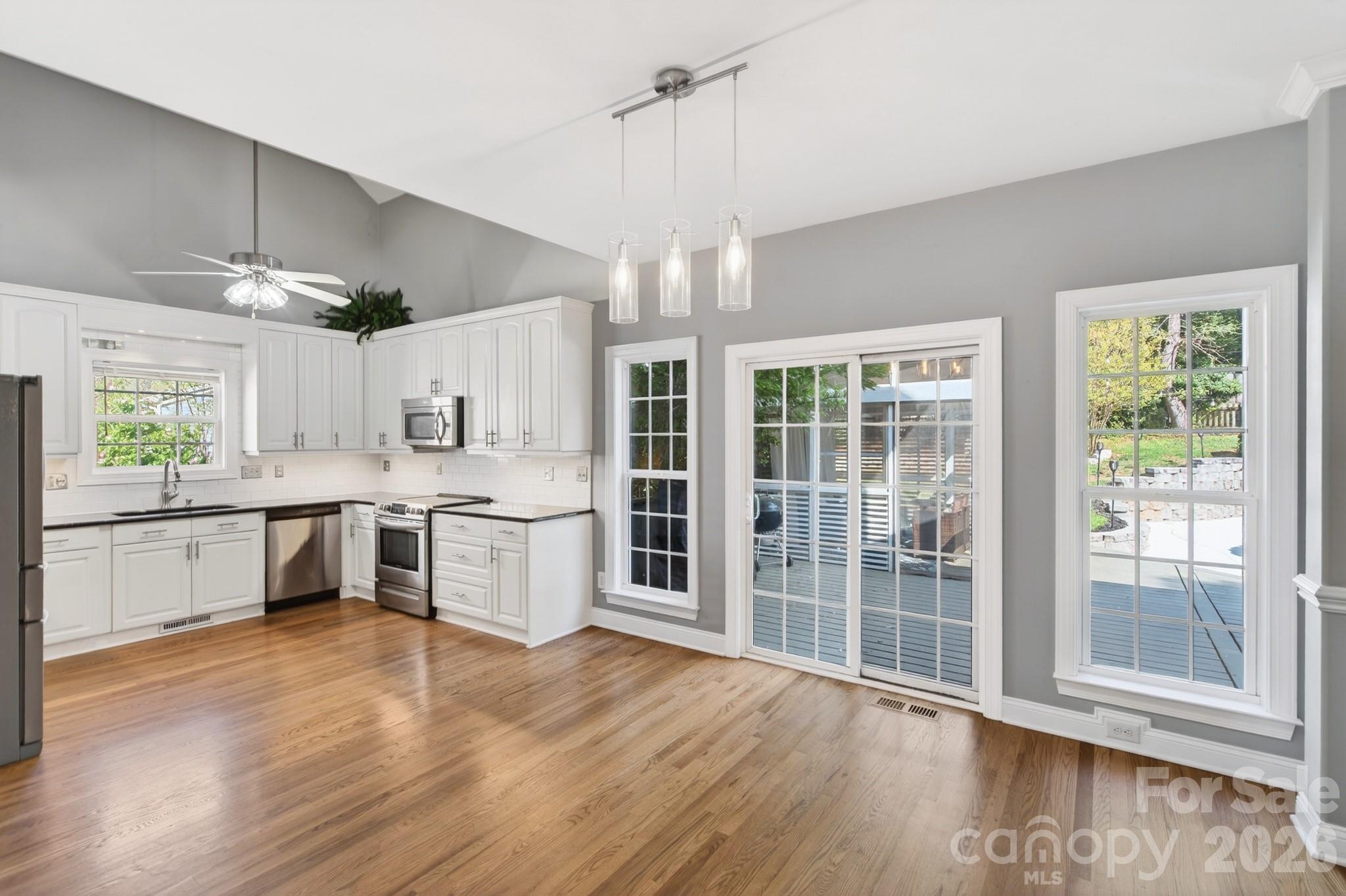 9101 Pitcairn Drive Tega Cay, SC 29708 - Photo 17 of 48 a large kitchen with a large window and stainless steel appliances