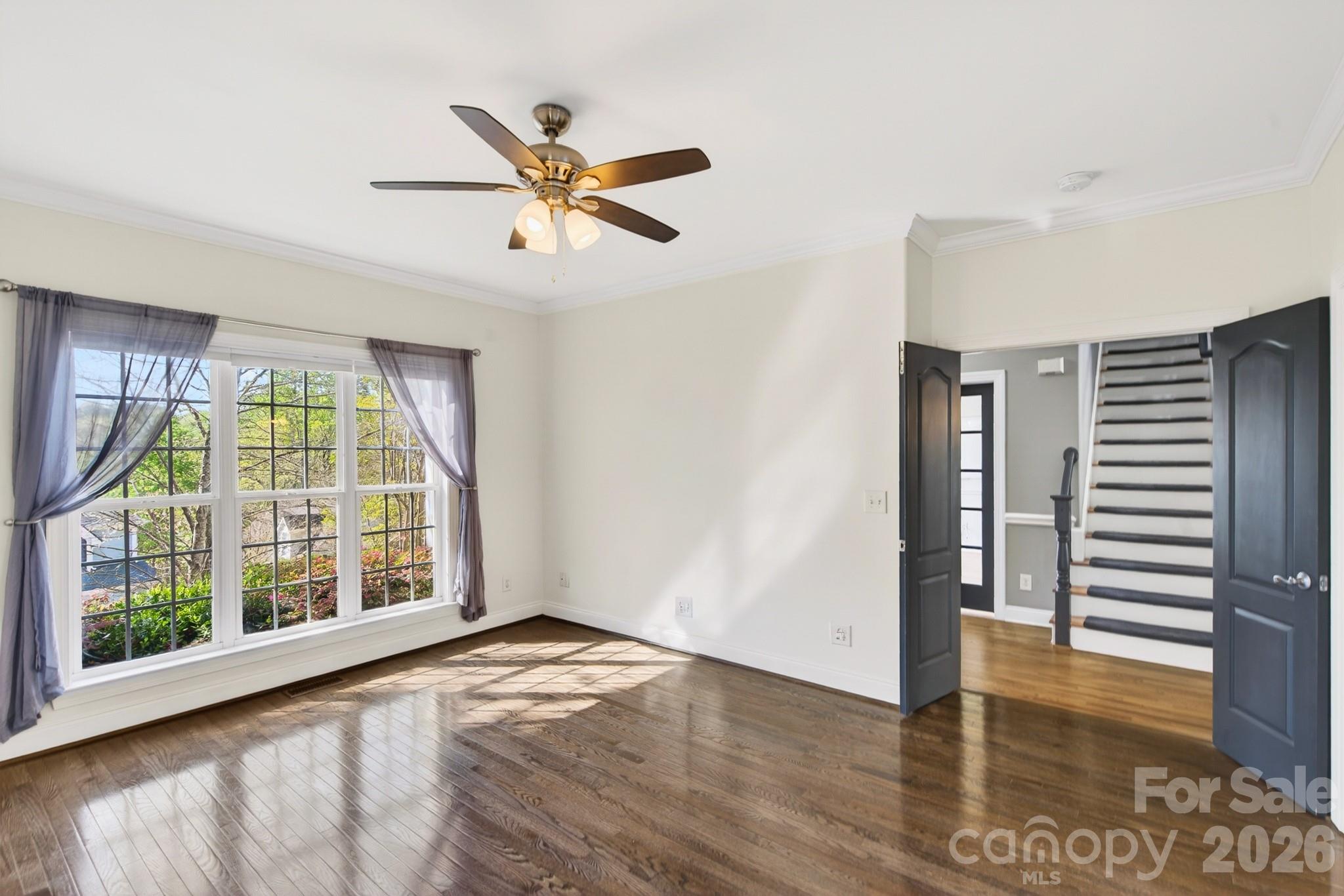9101 Pitcairn Drive Tega Cay, SC 29708 - Photo 21 of 48 a view of an empty room with wooden floor and a window