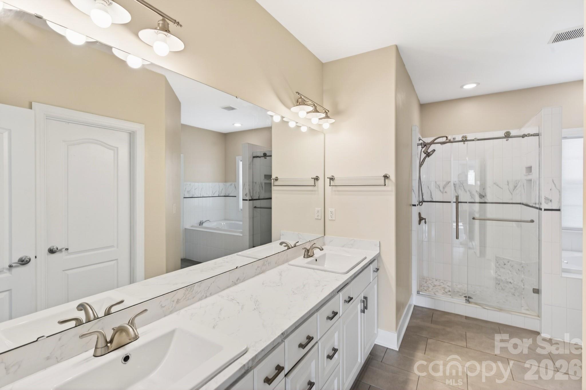 9101 Pitcairn Drive Tega Cay, SC 29708 - Photo 23 of 48 a bathroom with a double vanity sink mirror and shower