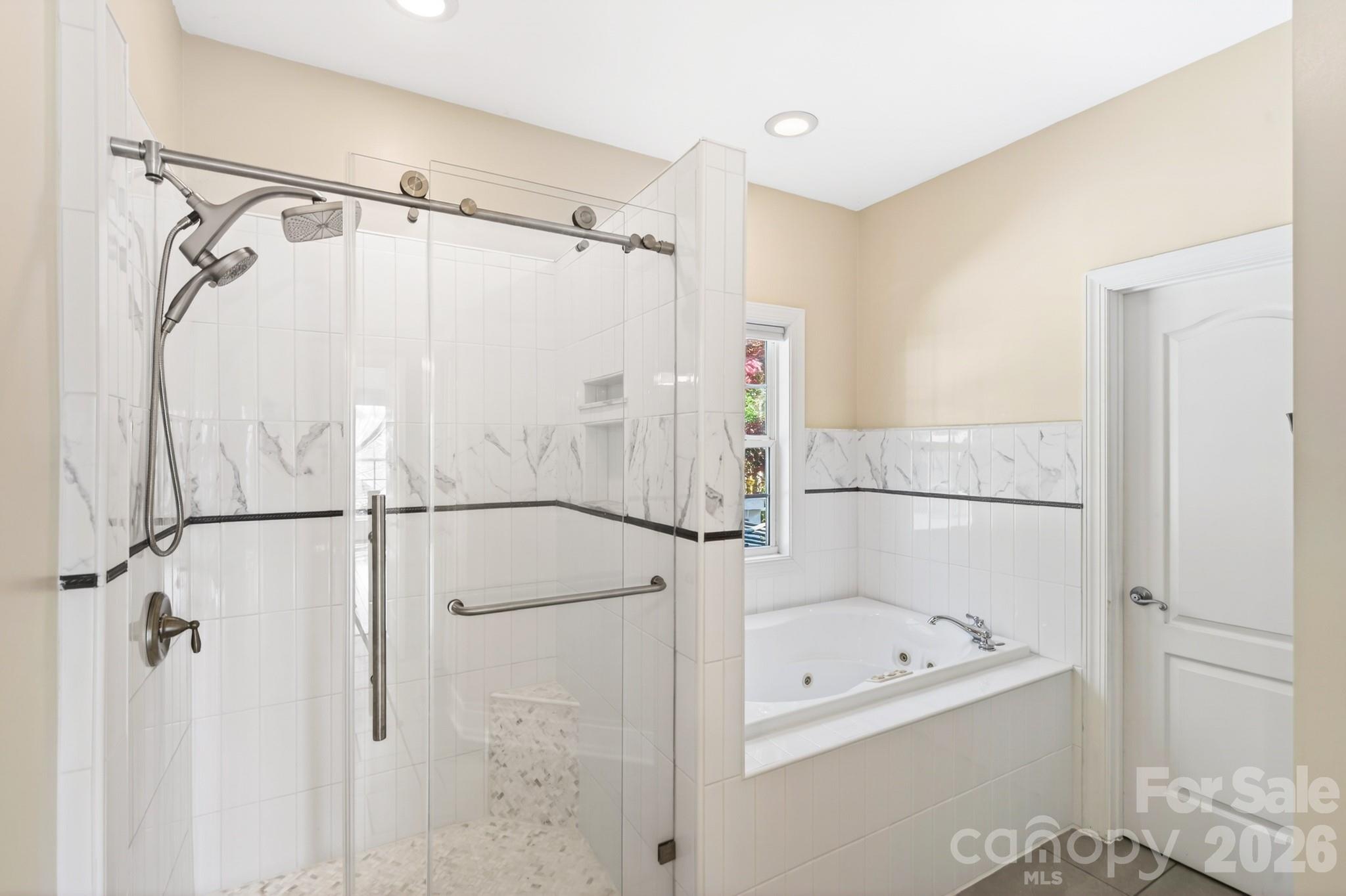 9101 Pitcairn Drive Tega Cay, SC 29708 - Photo 24 of 48 a bathroom with a bathtub and a shower
