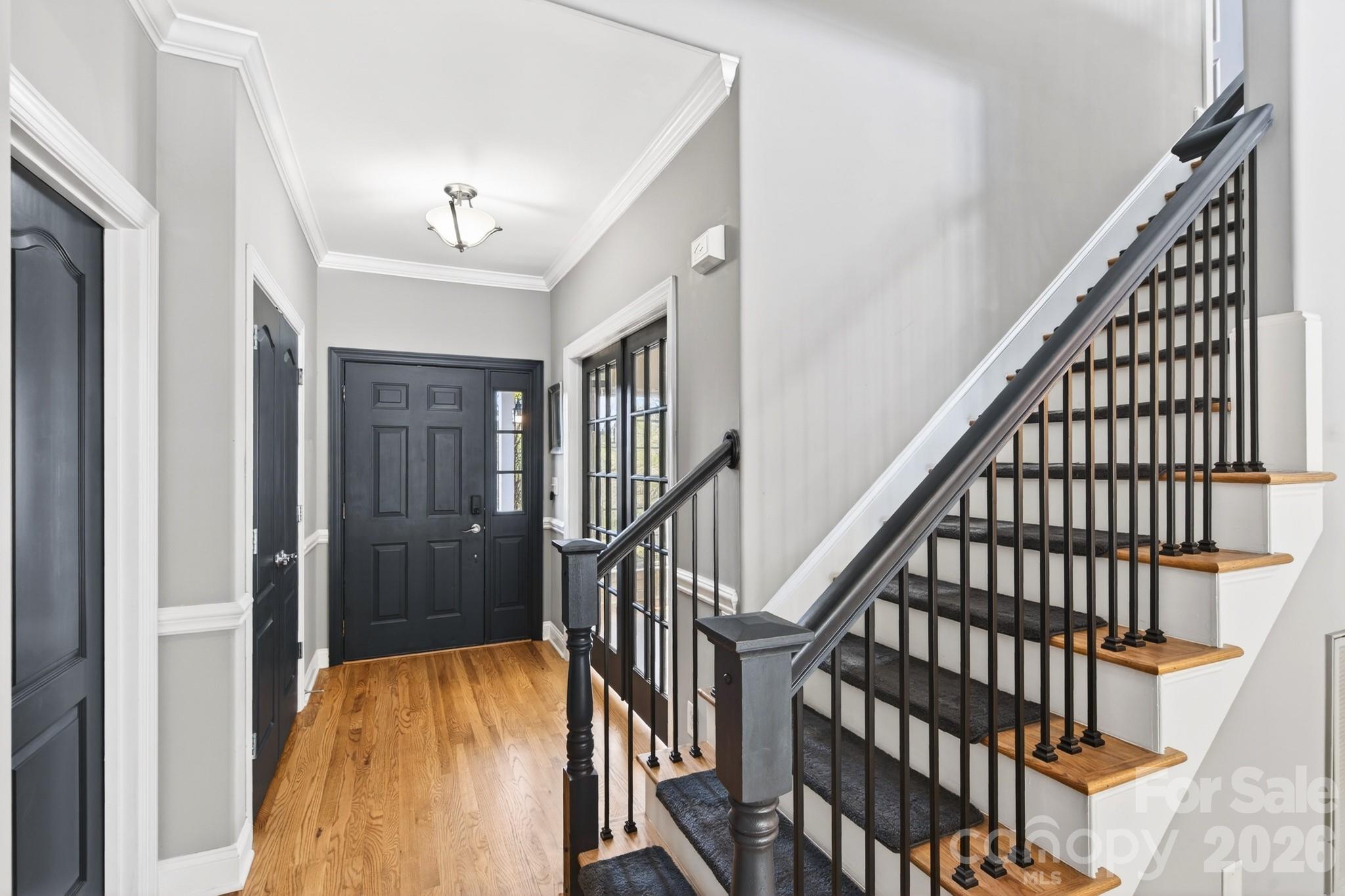 9101 Pitcairn Drive Tega Cay, SC 29708 - Photo 26 of 48 a view of staircase with wooden floor and fan