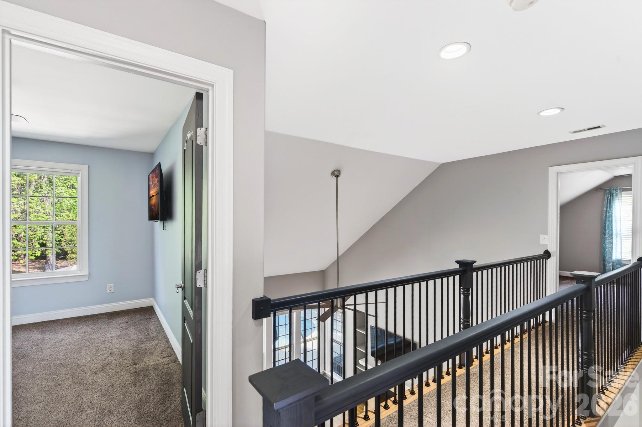 9101 Pitcairn Drive Tega Cay, SC 29708 - Photo 27 of 48 a view of a hallway with windows and stairs