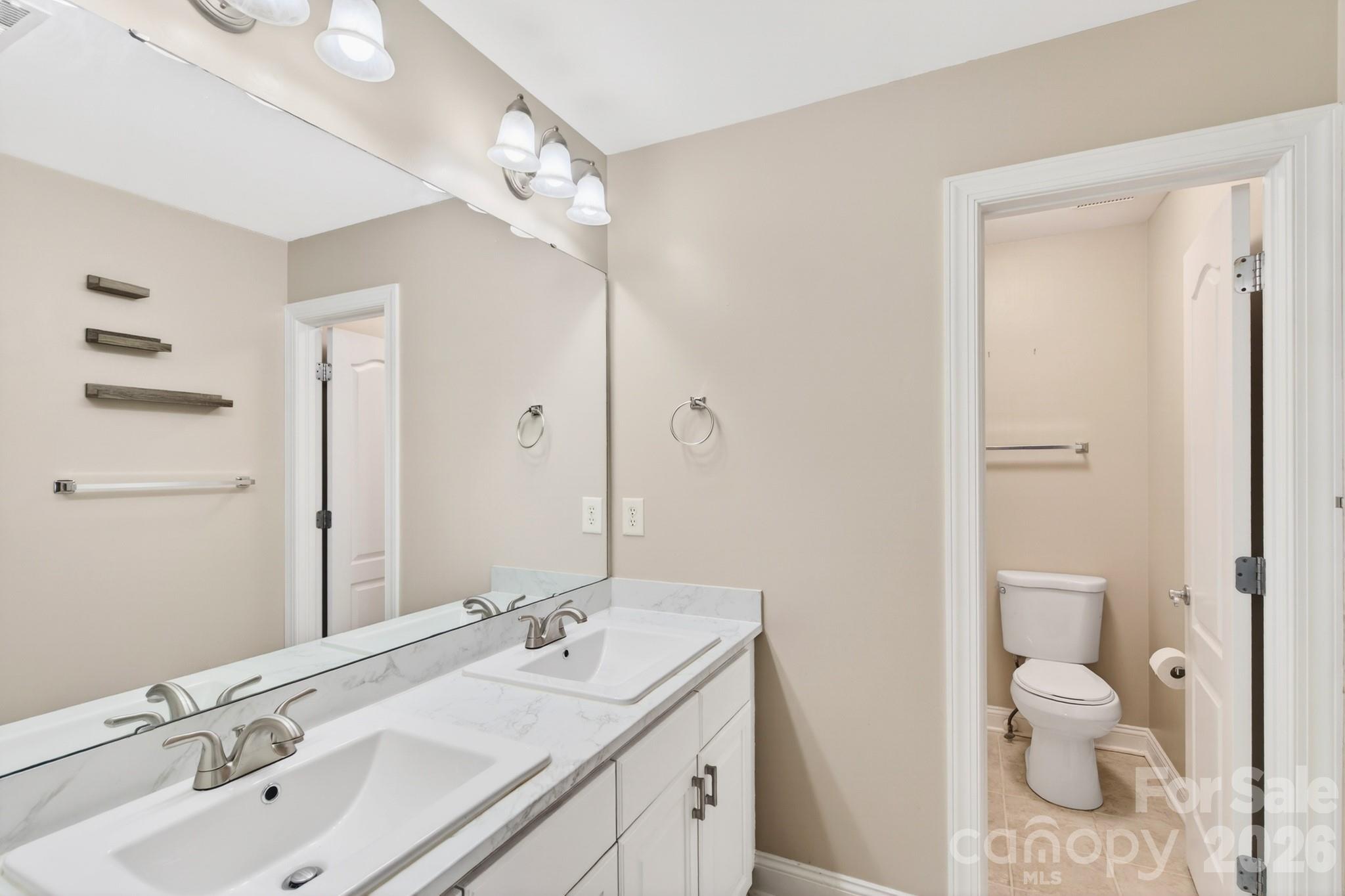 9101 Pitcairn Drive Tega Cay, SC 29708 - Photo 29 of 48 a bathroom with a sink a toilet and shower