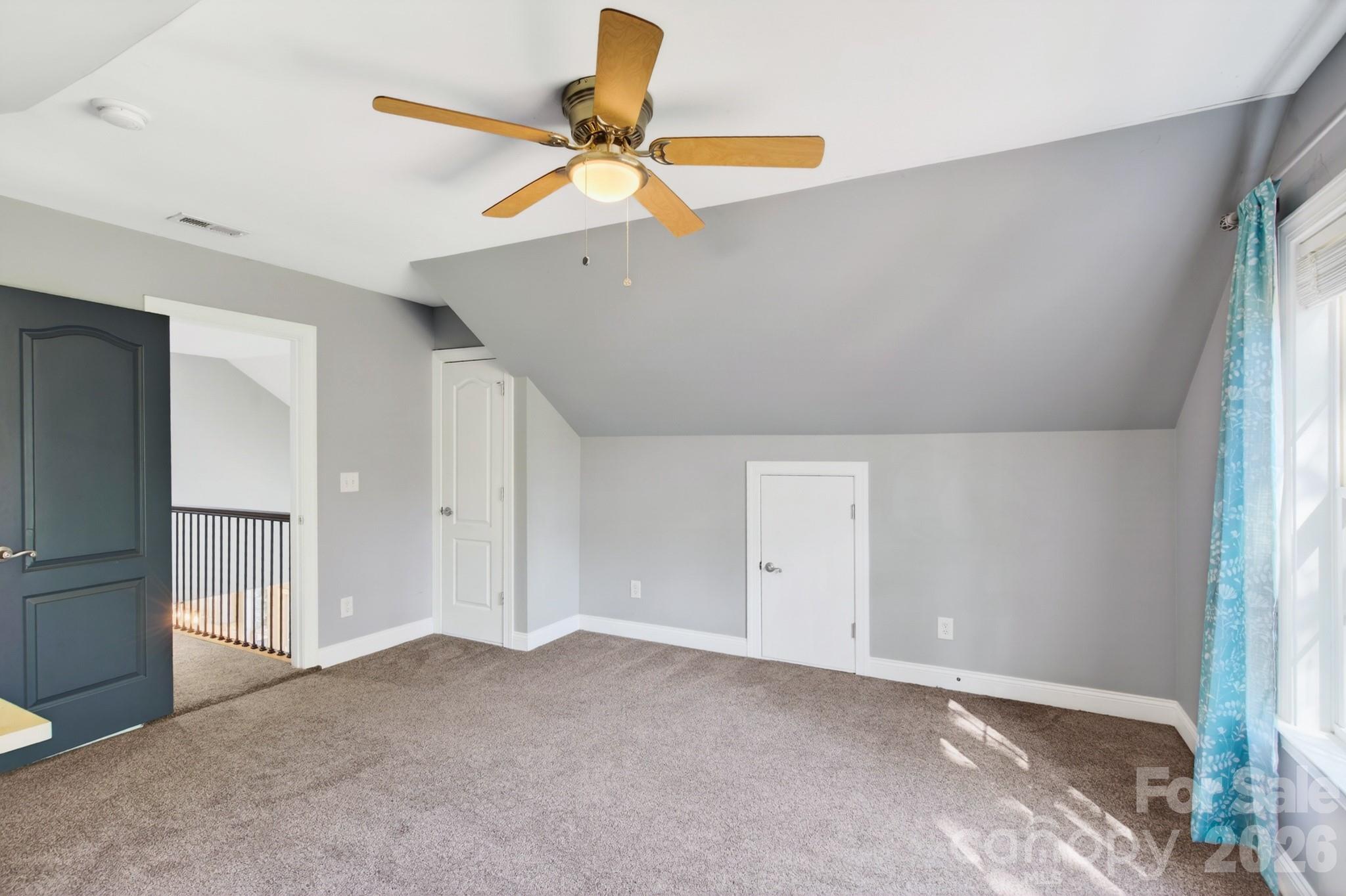 9101 Pitcairn Drive Tega Cay, SC 29708 - Photo 32 of 48 an empty room with a ceiling fan and carpet