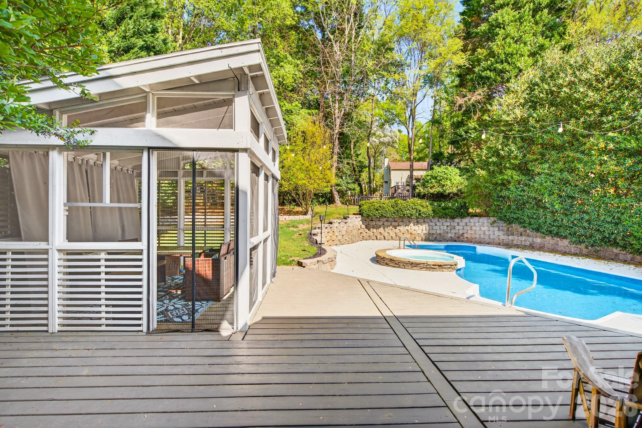 9101 Pitcairn Drive Tega Cay, SC 29708 - Photo 38 of 48 a view of a patio with couches and table and chairs with wooden floor and fence