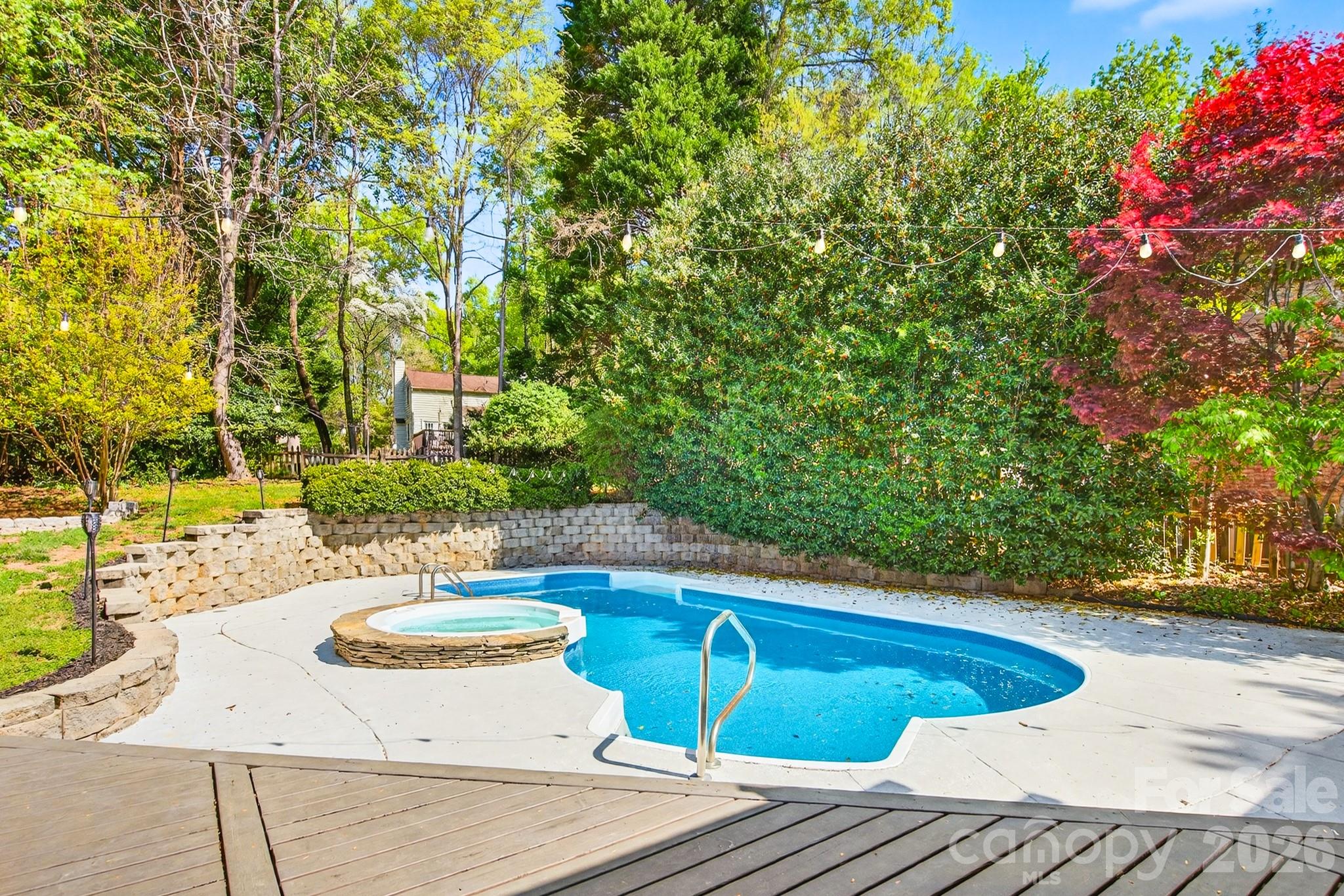 9101 Pitcairn Drive Tega Cay, SC 29708 - Photo 40 of 48 a view of a swimming pool with a patio
