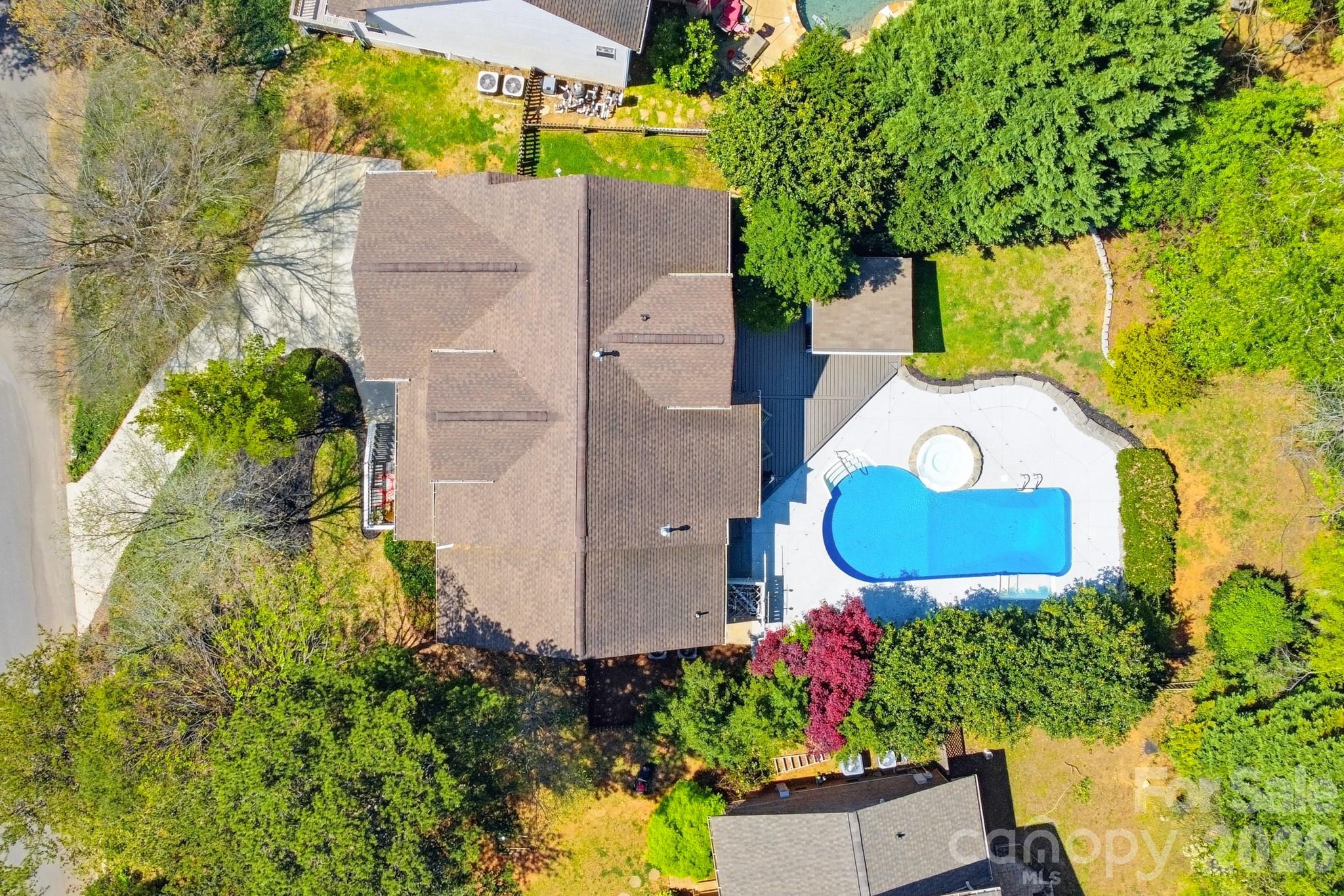9101 Pitcairn Drive Tega Cay, SC 29708 - Photo 43 of 48 an aerial view of a house with a swimming pool and garden