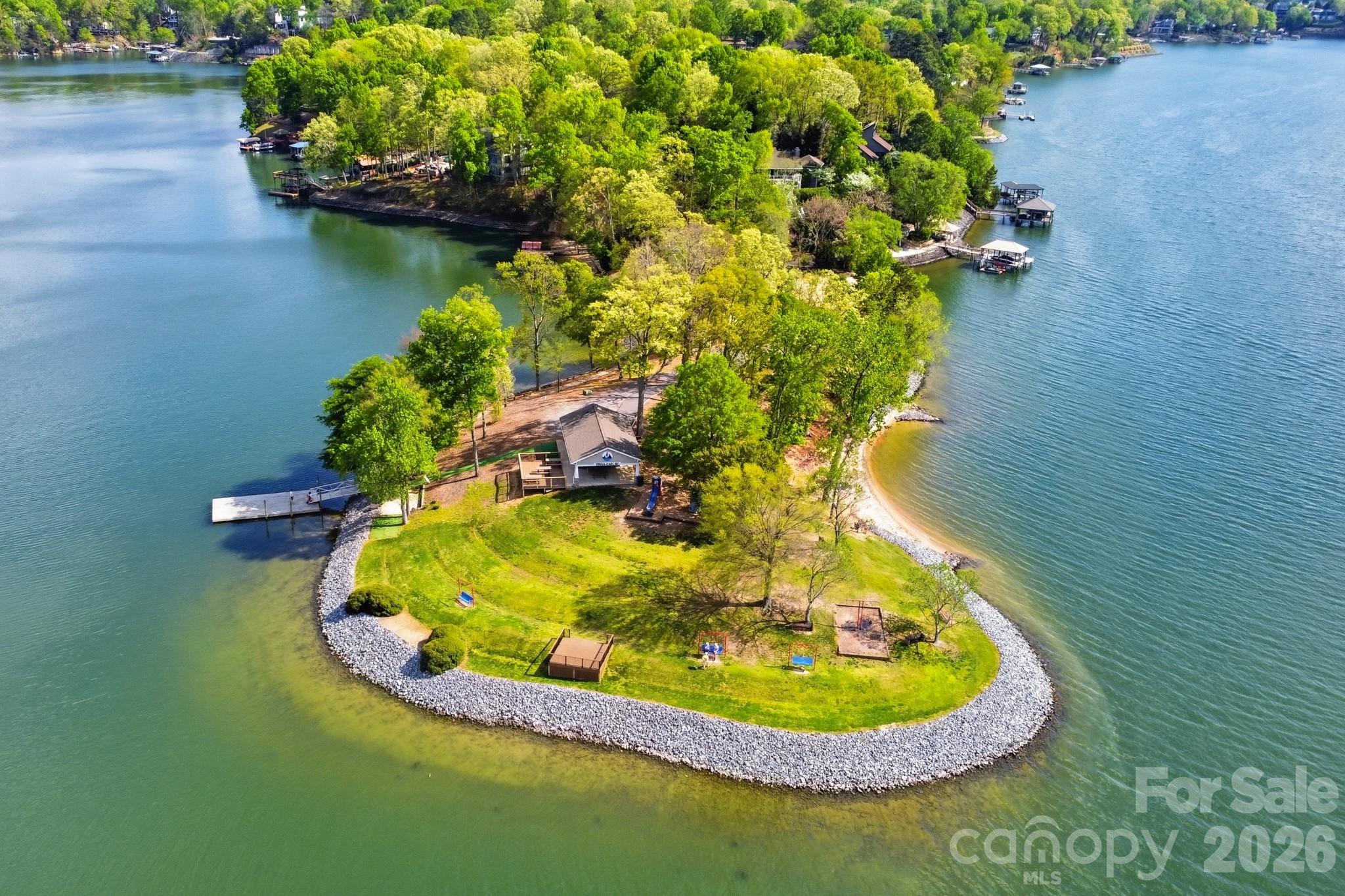 9101 Pitcairn Drive Tega Cay, SC 29708 - Photo 45 of 48 a view of a lake with a yard