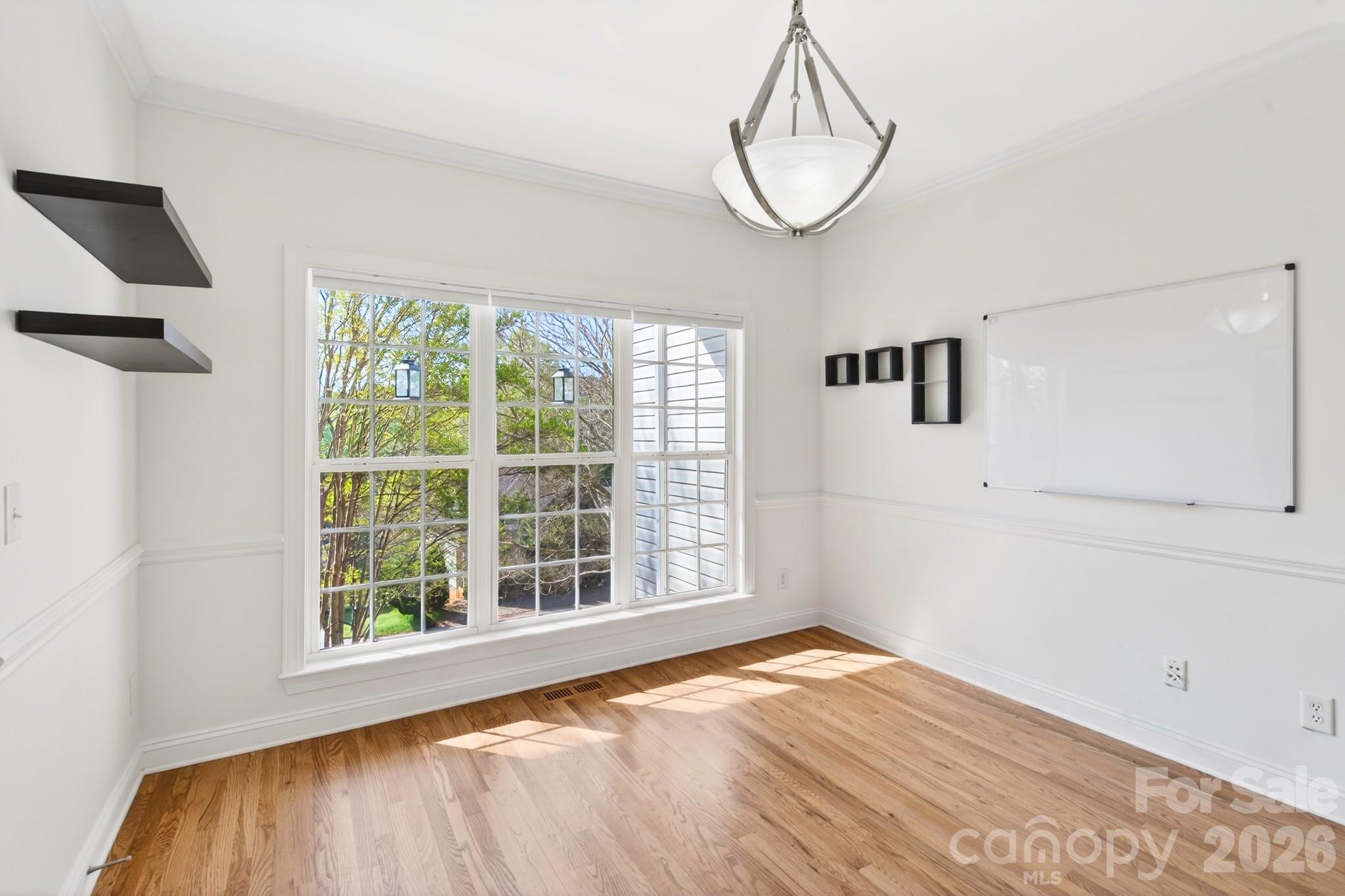 9101 Pitcairn Drive Tega Cay, SC 29708 - Photo 8 of 48 a view of empty room with wooden floor and fan