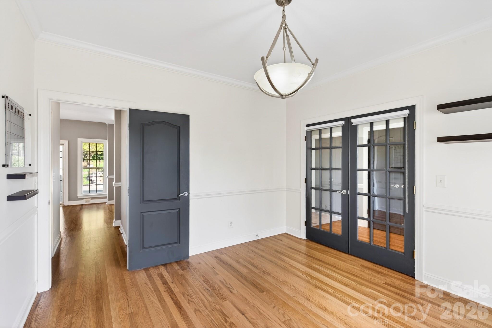 9101 Pitcairn Drive Tega Cay, SC 29708 - Photo 9 of 48 a view of empty room with wooden floor and fan