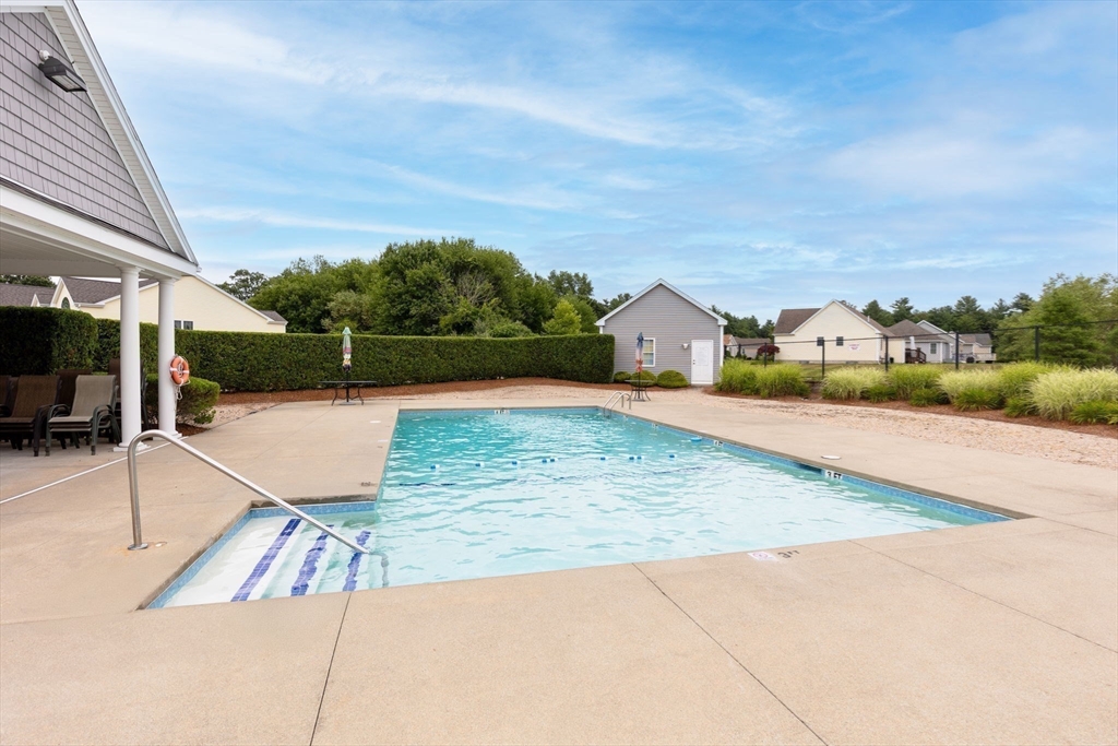 11 Deirdre Circle, Unit 11 Rehoboth, MA 02769 - Photo 14 of 17 a view of a swimming pool with a lounge chairs