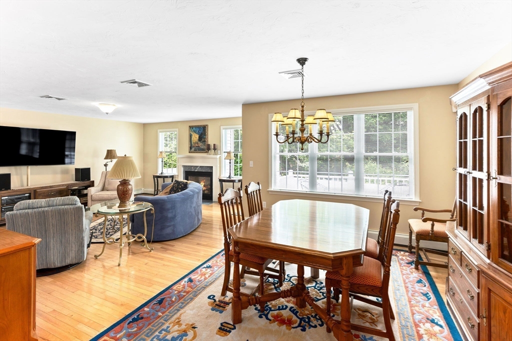 11 Deirdre Circle, Unit 11 Rehoboth, MA 02769 - Photo 3 of 17 a living room with fireplace furniture and a chandelier