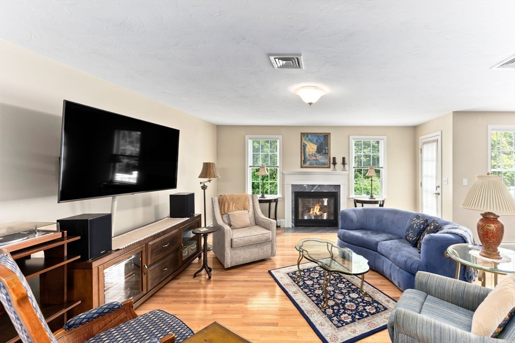 11 Deirdre Circle, Unit 11 Rehoboth, MA 02769 - Photo 4 of 17 a living room with furniture a flat screen tv and a fireplace