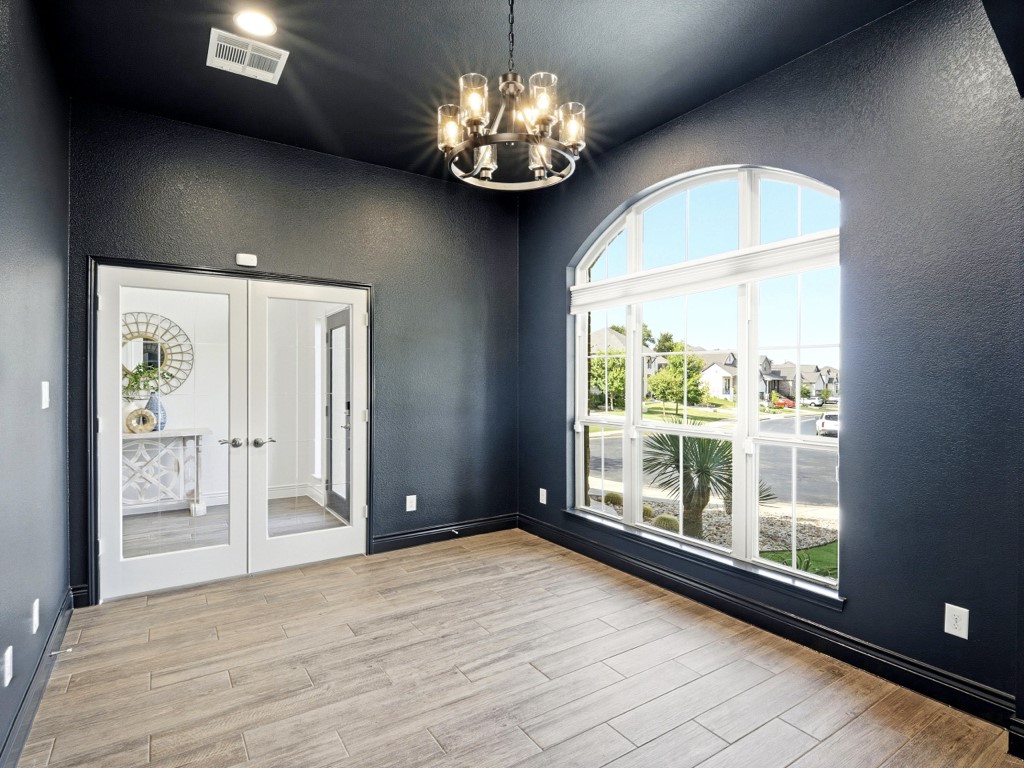 109 Lake Spring Circle Georgetown, TX 78633 - Photo 6 of 38 Natural light floods this front office / versatile space through an elegant arched window.