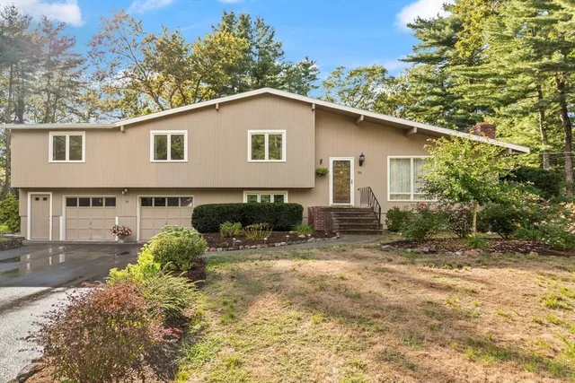 a view of a house with a yard and plants