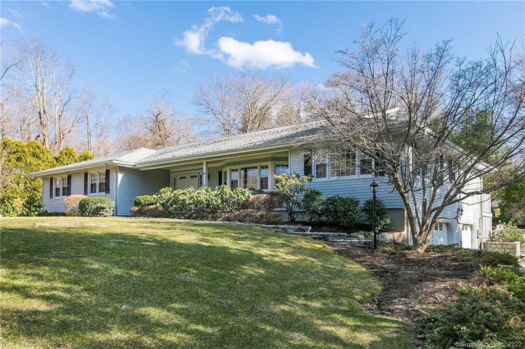17 Holmes Road Ridgefield, CT 06877 - Photo 1 of 1 a front view of a house with a yard