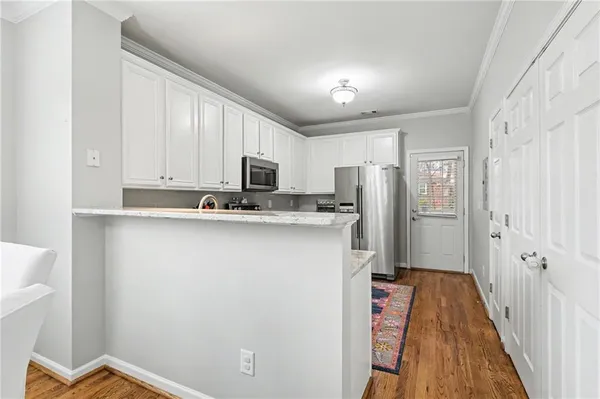 a kitchen with stainless steel appliances a refrigerator sink and microwave