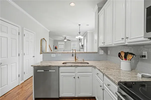 a kitchen with white cabinets and a sink