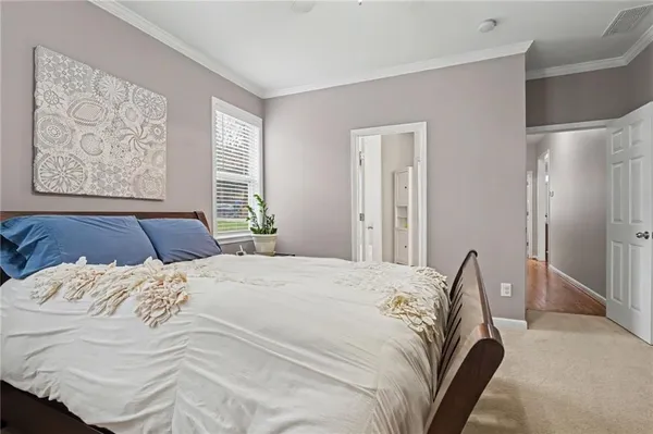 a bedroom with a large bed and a chandelier