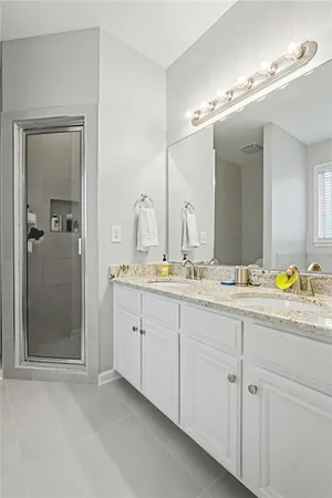 a bathroom with double sink and a mirror