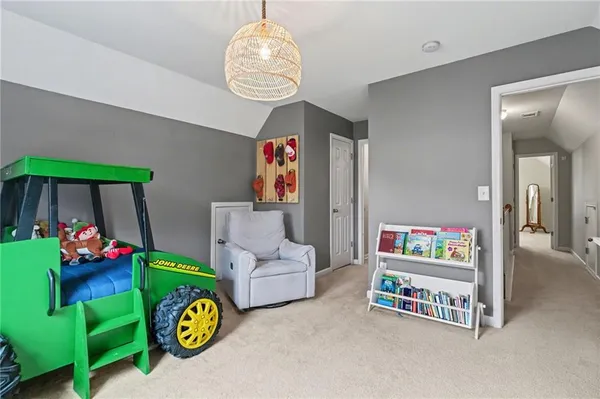 a play room with furniture and a chandelier