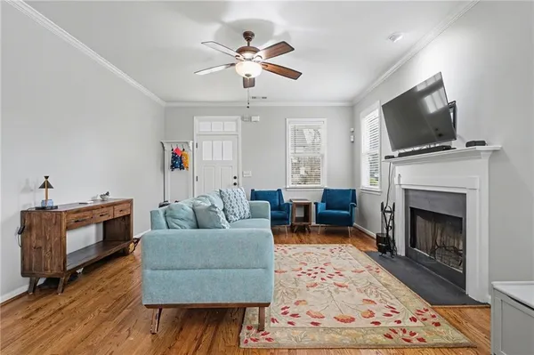 a living room with furniture a flat screen tv and a fireplace