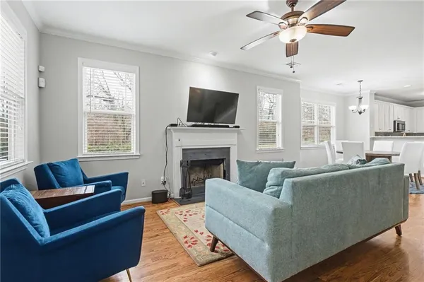 a living room with furniture a flat screen tv and a fireplace