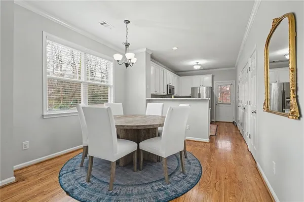 a view of a dining room with furniture window and wooden floor