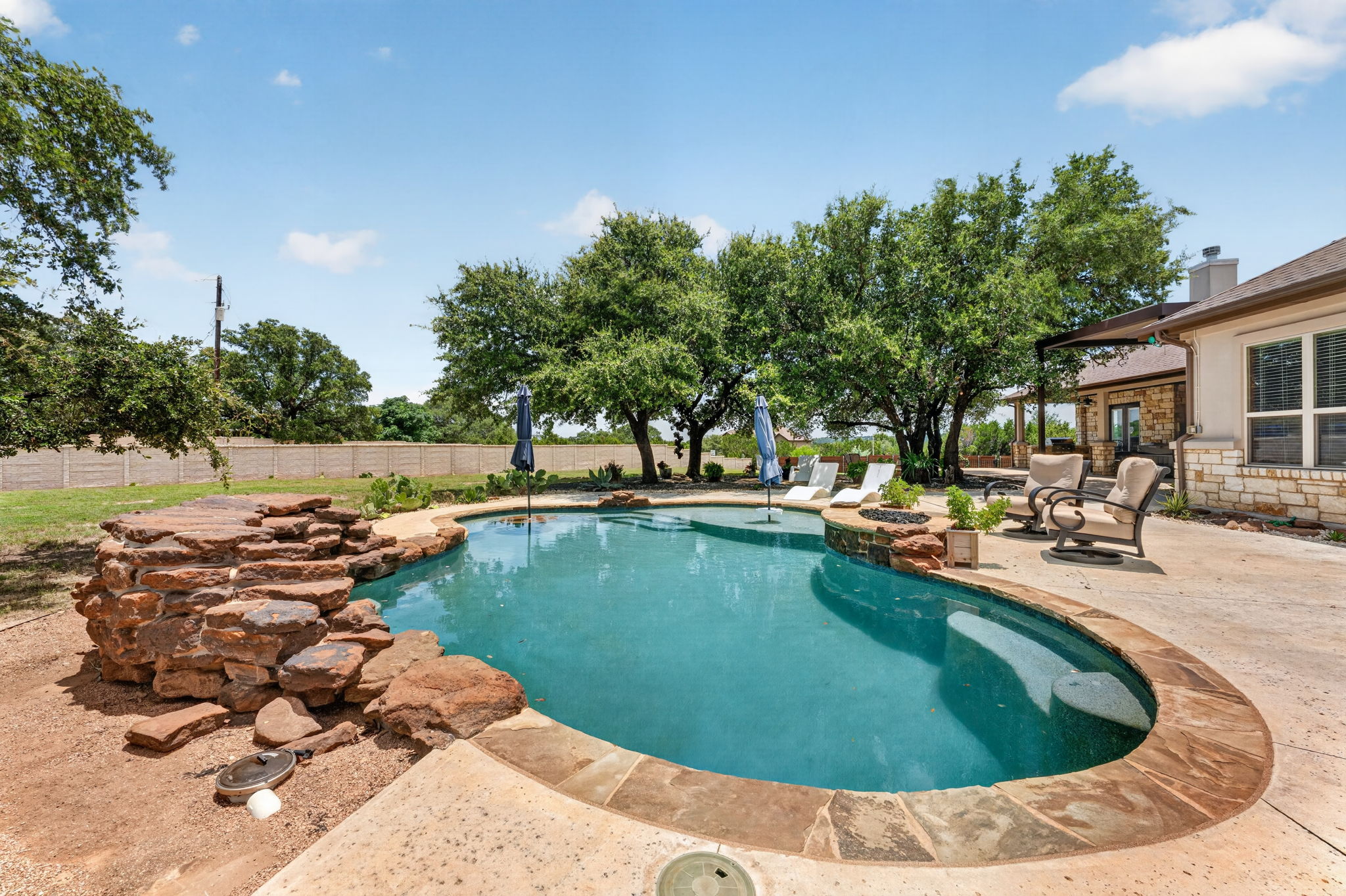 105 Coopers Hill Road Georgetown, TX 78633 - Photo 36 of 40 a view of swimming pool with outdoor seating and plants