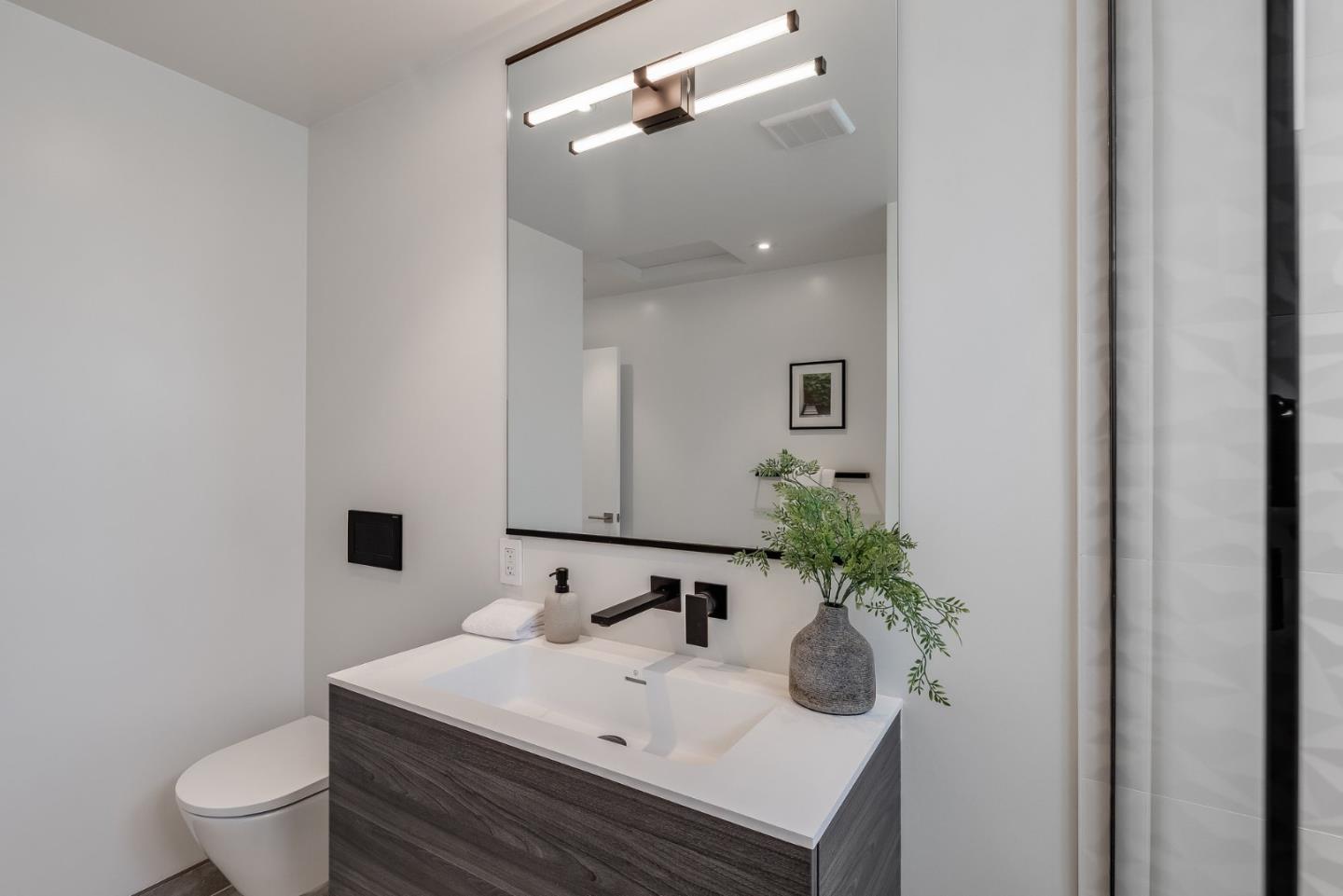 139 Victoria Road Burlingame, CA 94010 - Photo 30 of 72 a bathroom with a sink toilet and mirror