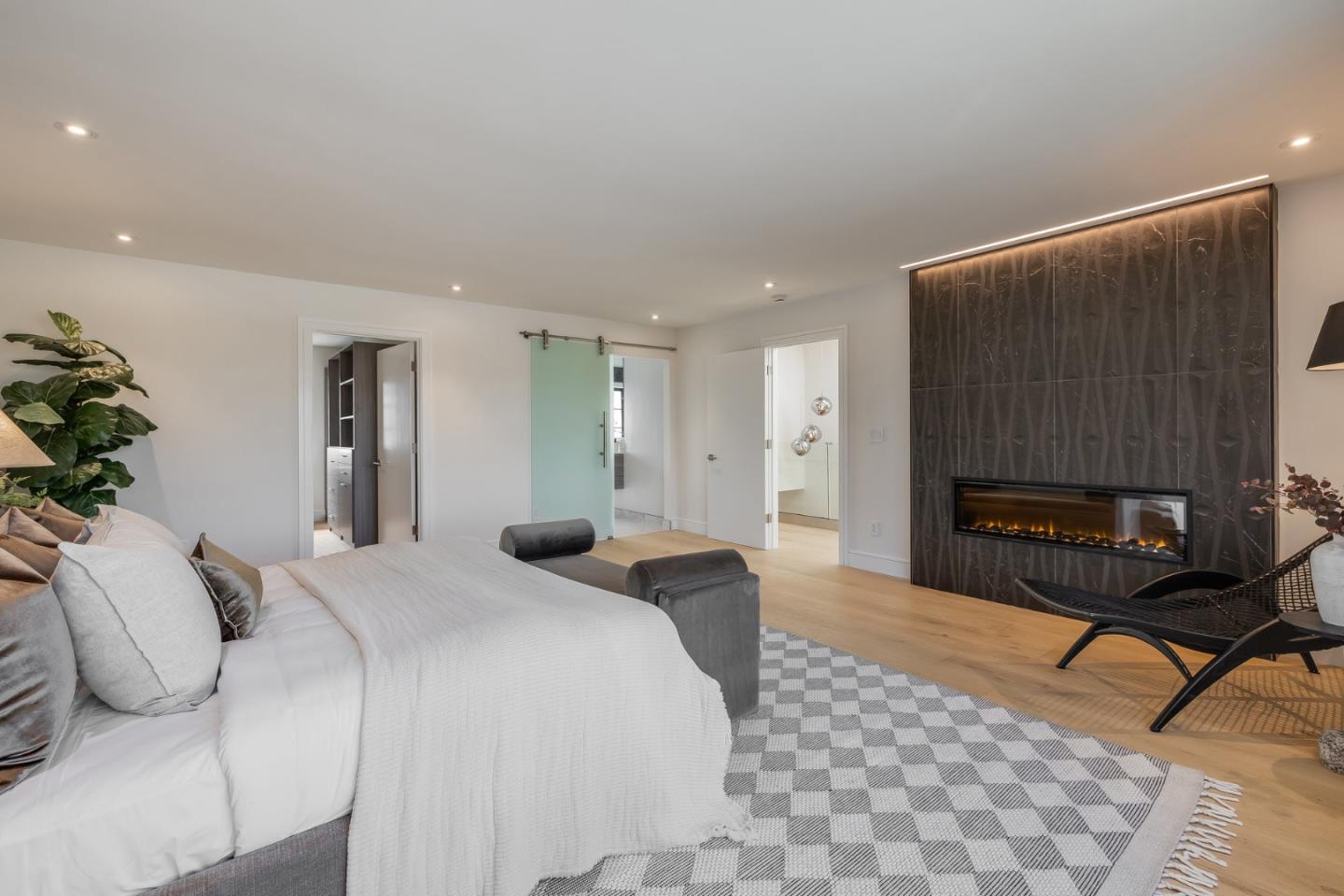 139 Victoria Road Burlingame, CA 94010 - Photo 37 of 72 a spacious bedroom with a bed a couch and a potted plant