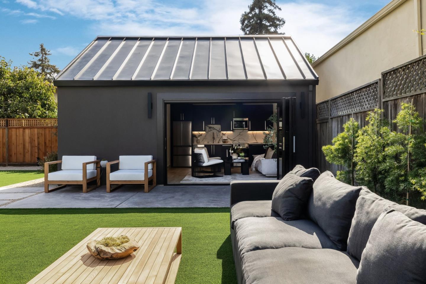 139 Victoria Road Burlingame, CA 94010 - Photo 58 of 72 a view of a patio with couches table and chairs with potted plants
