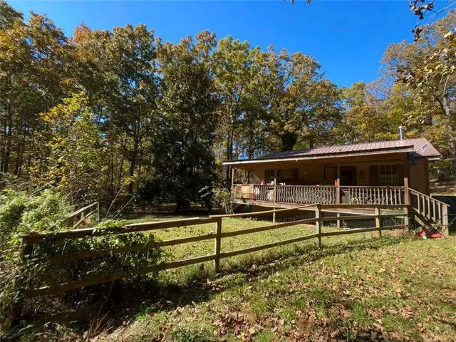 a view of a deck with a bench and trees