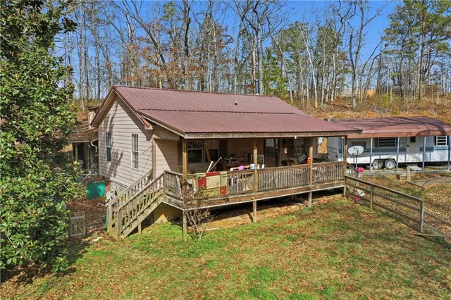 a view of a house with a yard patio and deck