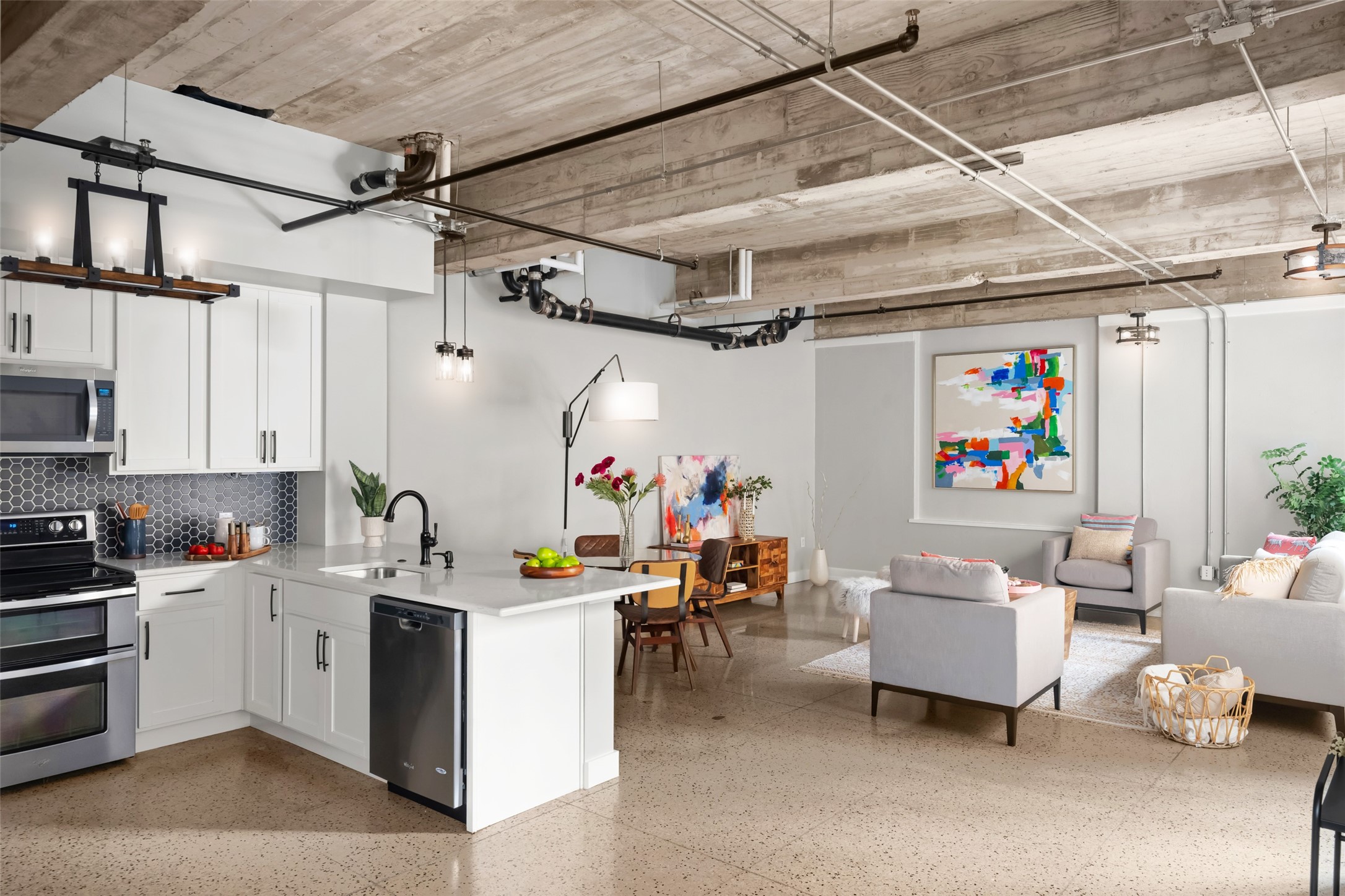 710 Colorado Street, Unit 2J Austin, TX 78701 - Photo 1 of 1 Tall ceilings with exposed beams, conduit, and ductwork throughout are well complimented by updated designer fixtures.