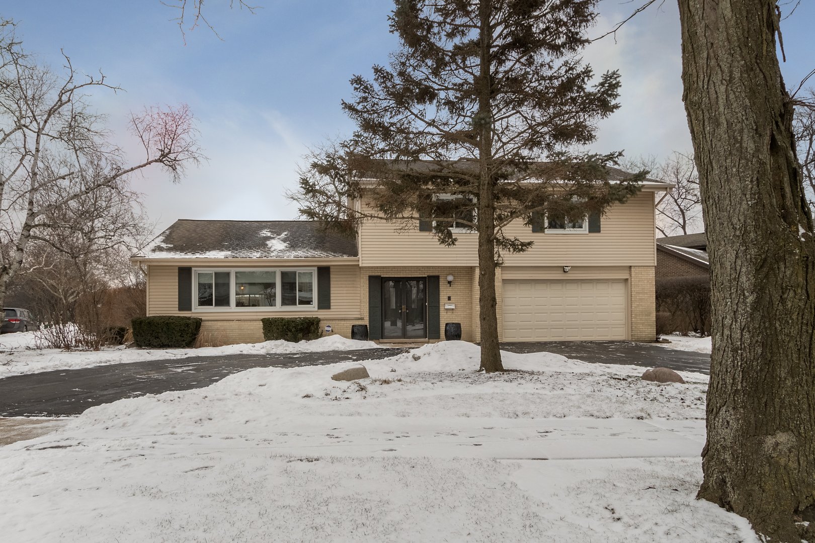 29 Ellendale Road Deerfield, IL 60015 - Photo 1 of 35 a front view of a house with a yard covered with snow