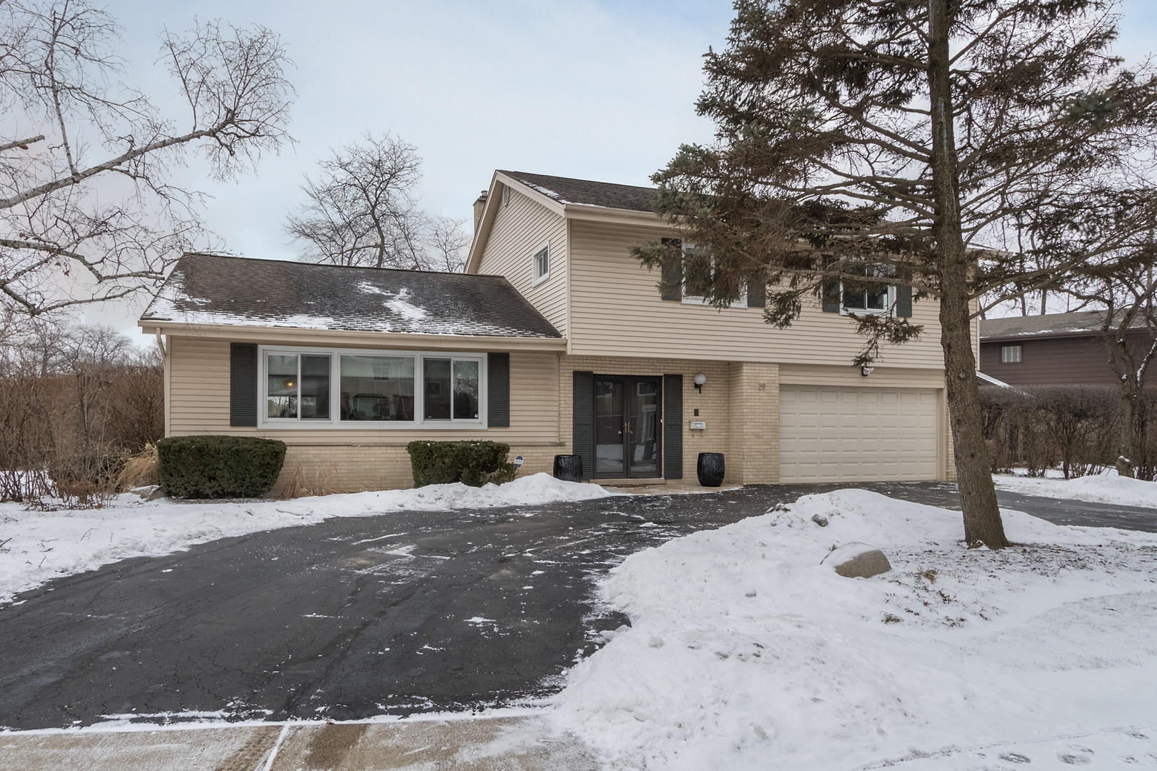 29 Ellendale Road Deerfield, IL 60015 - Photo 33 of 35 a front view of a house with a yard covered with snow in front of house