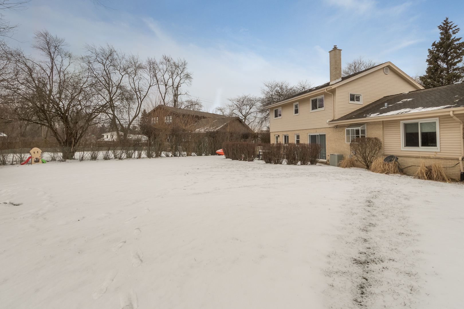 29 Ellendale Road Deerfield, IL 60015 - Photo 35 of 35 a front view of a house with a yard covered in snow