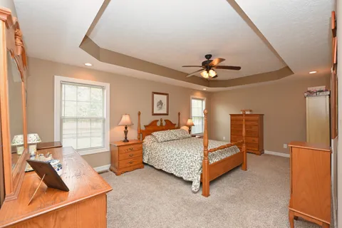 a bedroom with a bed and a chandelier