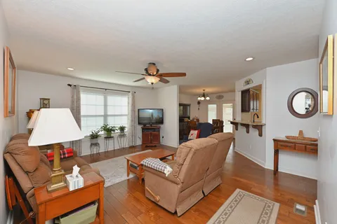 a living room with furniture and a wooden floor
