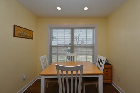 a view of a dining room with furniture and window