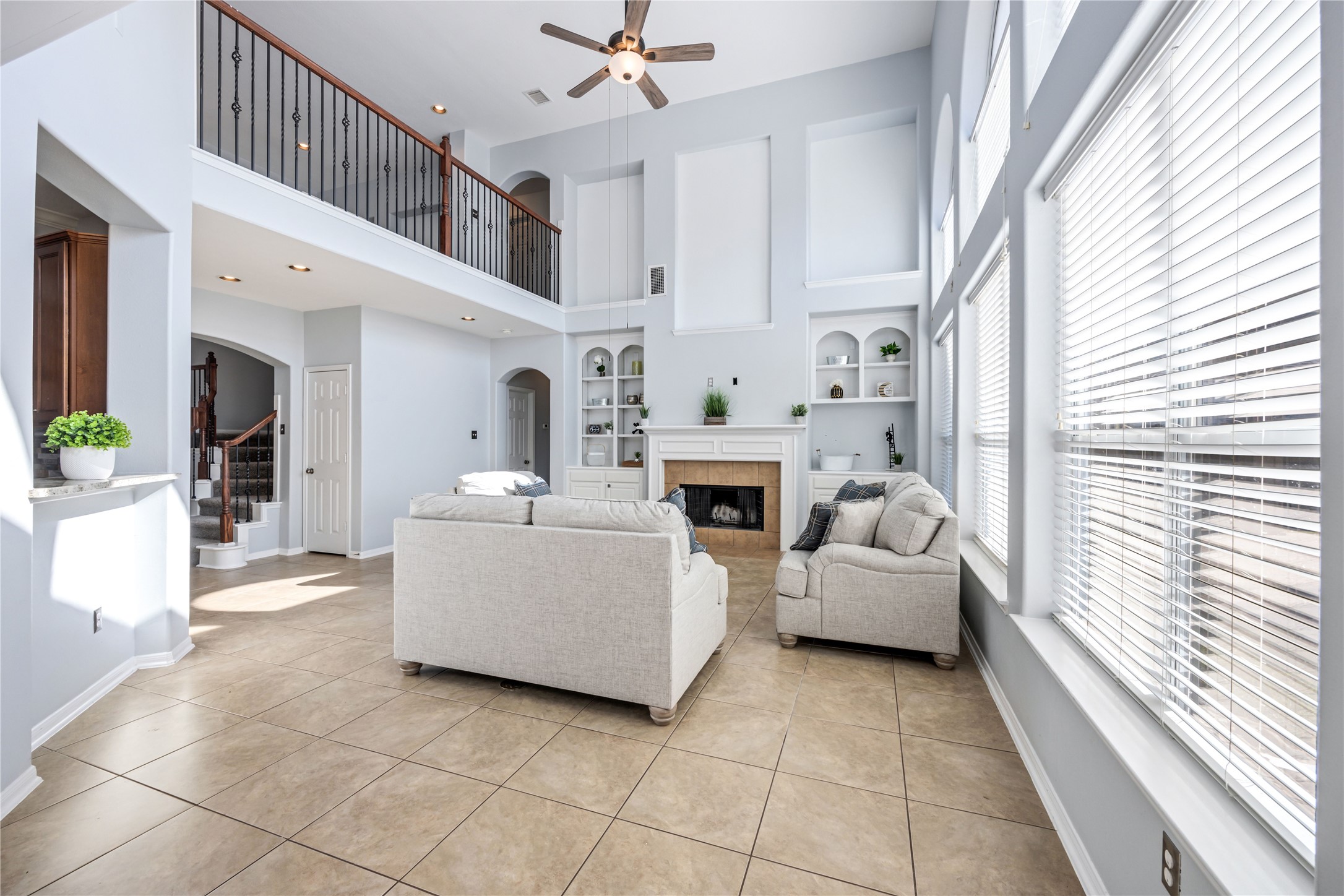 6727 Montay Bay Drive Spring, TX 77389 - Photo 16 of 41 a living room with furniture a fireplace and a large window
