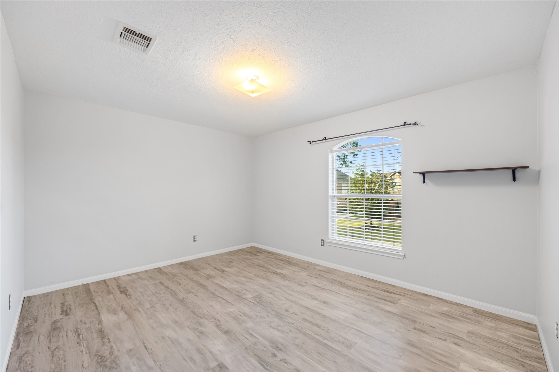 6727 Montay Bay Drive Spring, TX 77389 - Photo 25 of 41 an empty room with wooden floor and windows