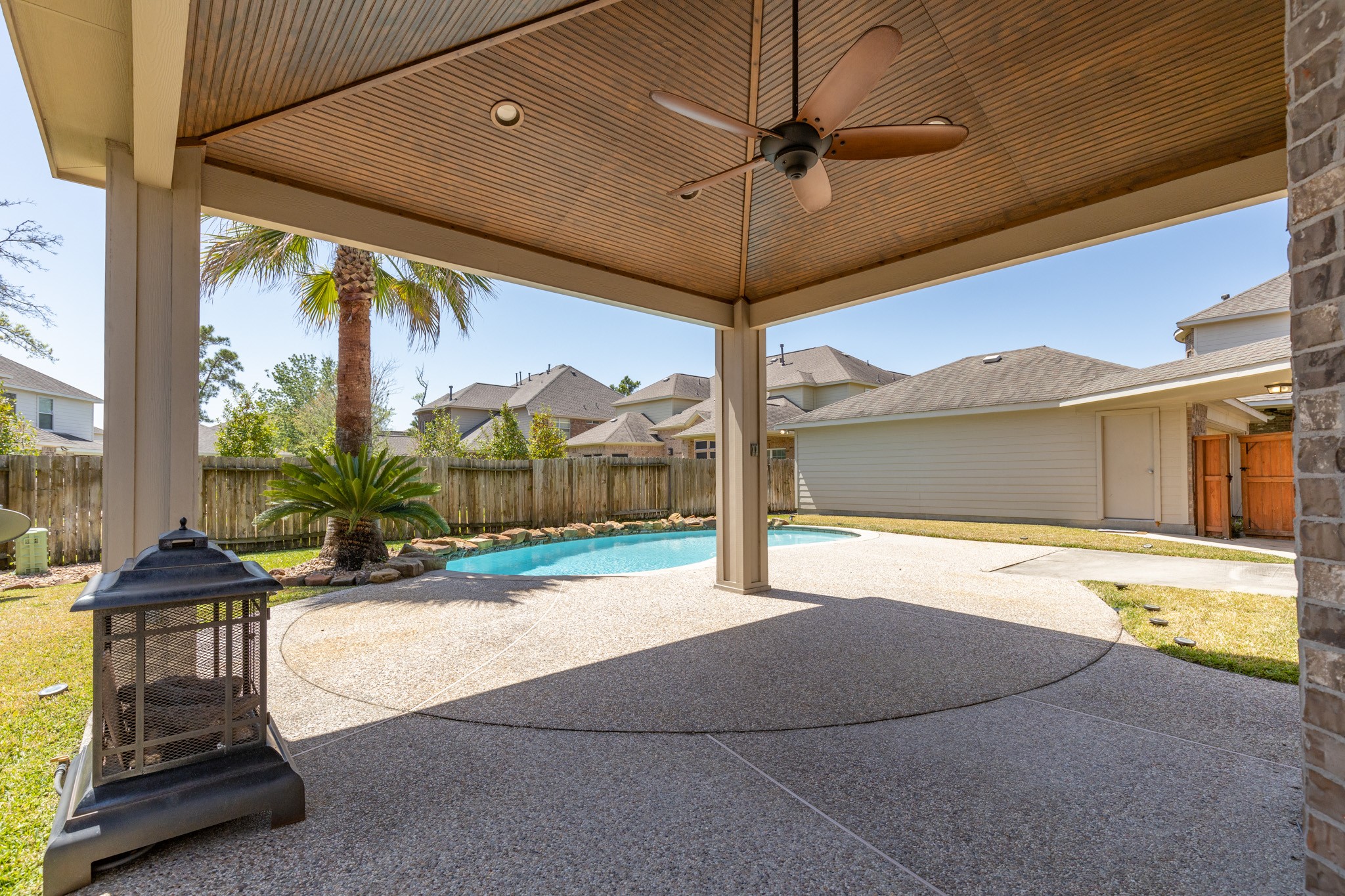 6727 Montay Bay Drive Spring, TX 77389 - Photo 32 of 41 a view of a porch with a floor to ceiling windows and a table