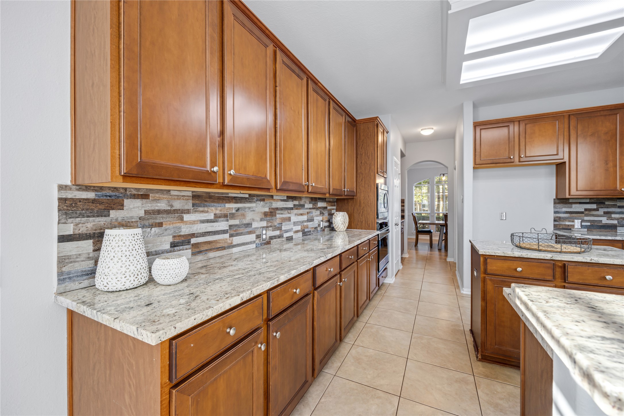 6727 Montay Bay Drive Spring, TX 77389 - Photo 10 of 41 a kitchen with stainless steel appliances granite countertop a stove a sink and a microwave