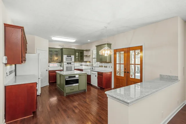 a kitchen with a sink stove and cabinets