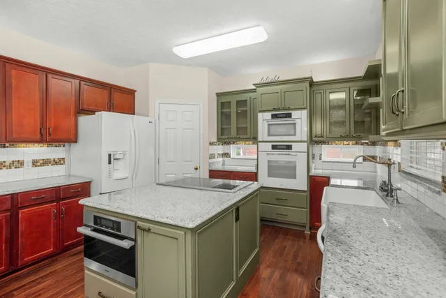 a kitchen that has a sink and a stove in it