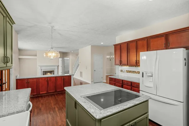 a kitchen with refrigerator cabinets and wooden floor